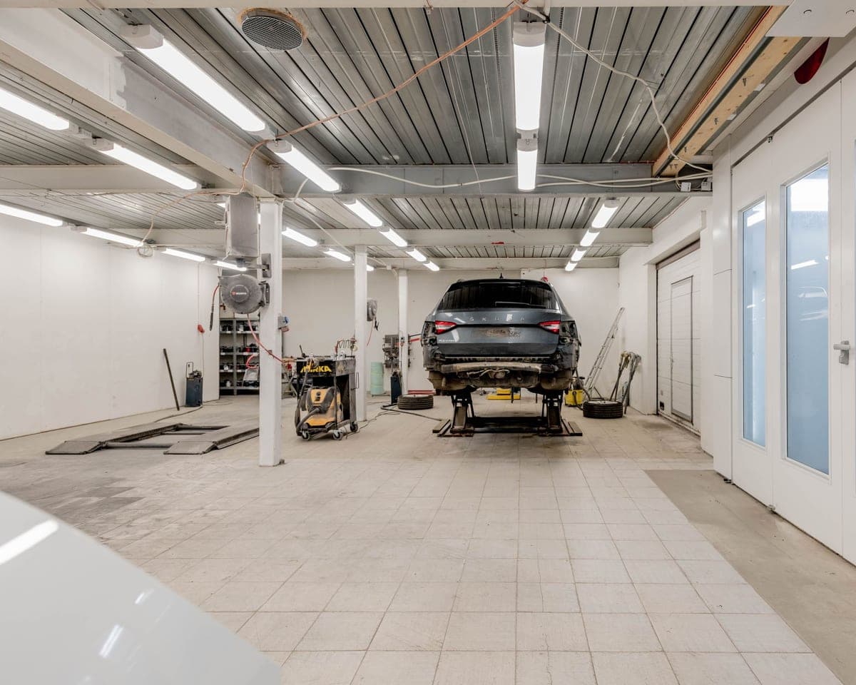 A vehicle raised on a lift in a clean service bay