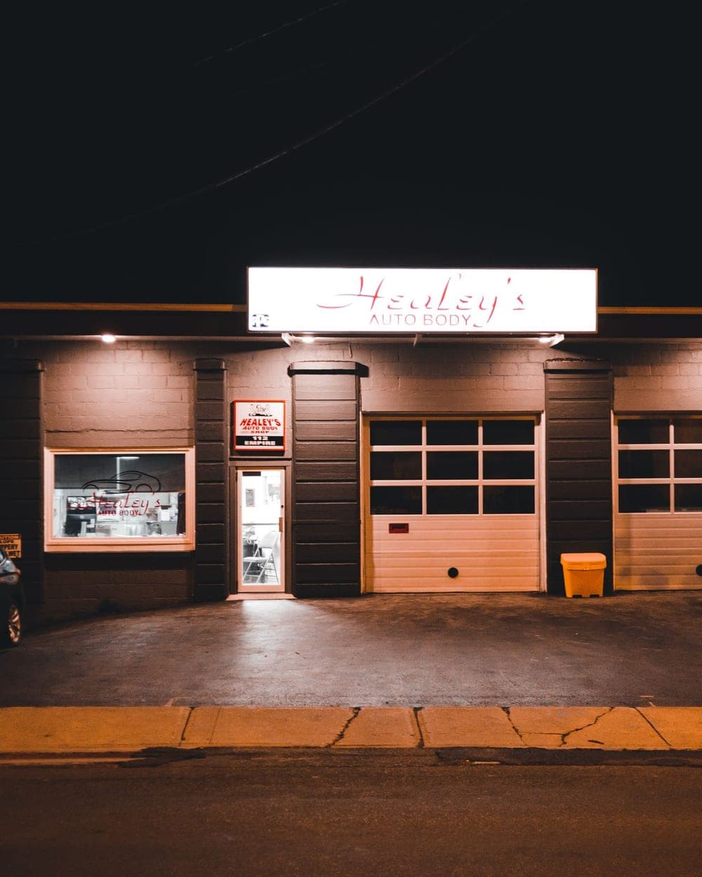 The shop exterior with service bay doors open