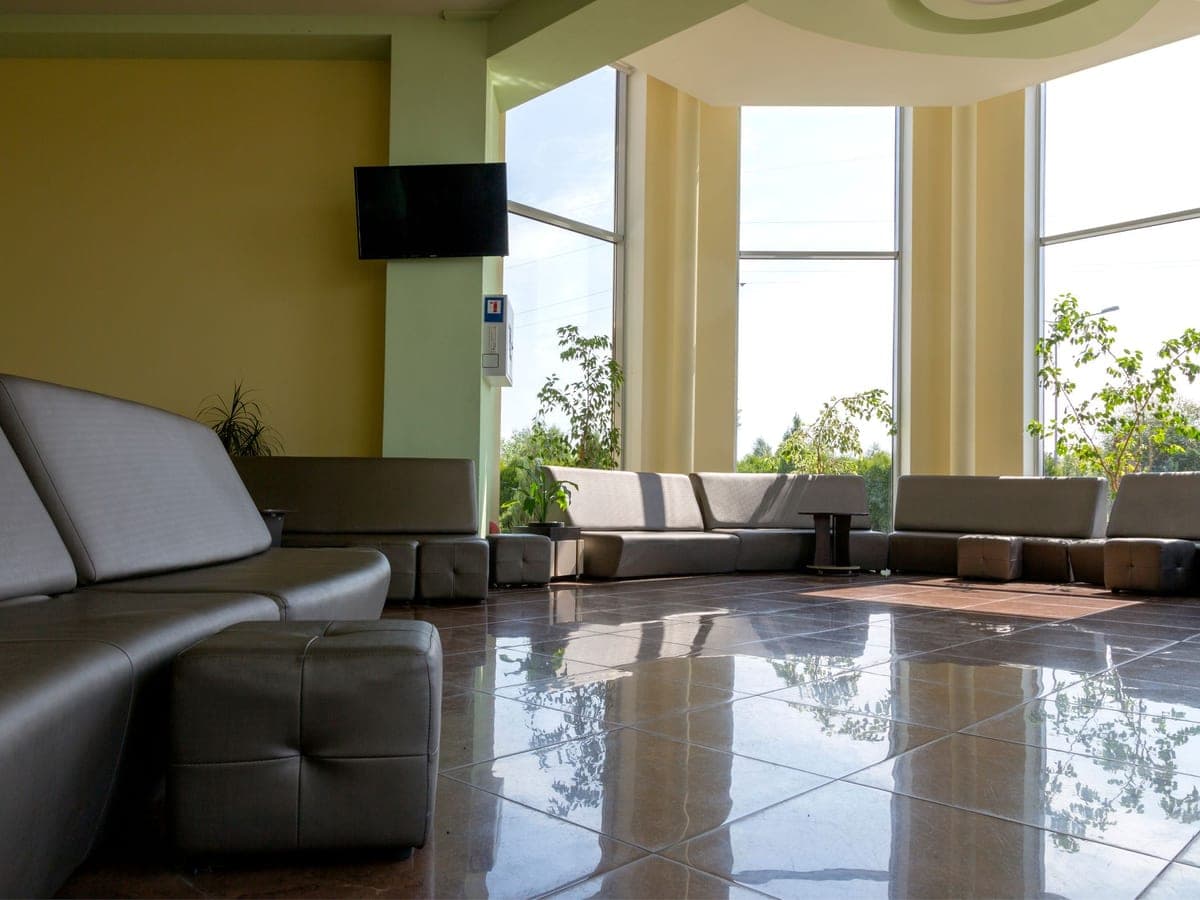 A bright customer lounge with comfortable seating and floor-to-ceiling windows